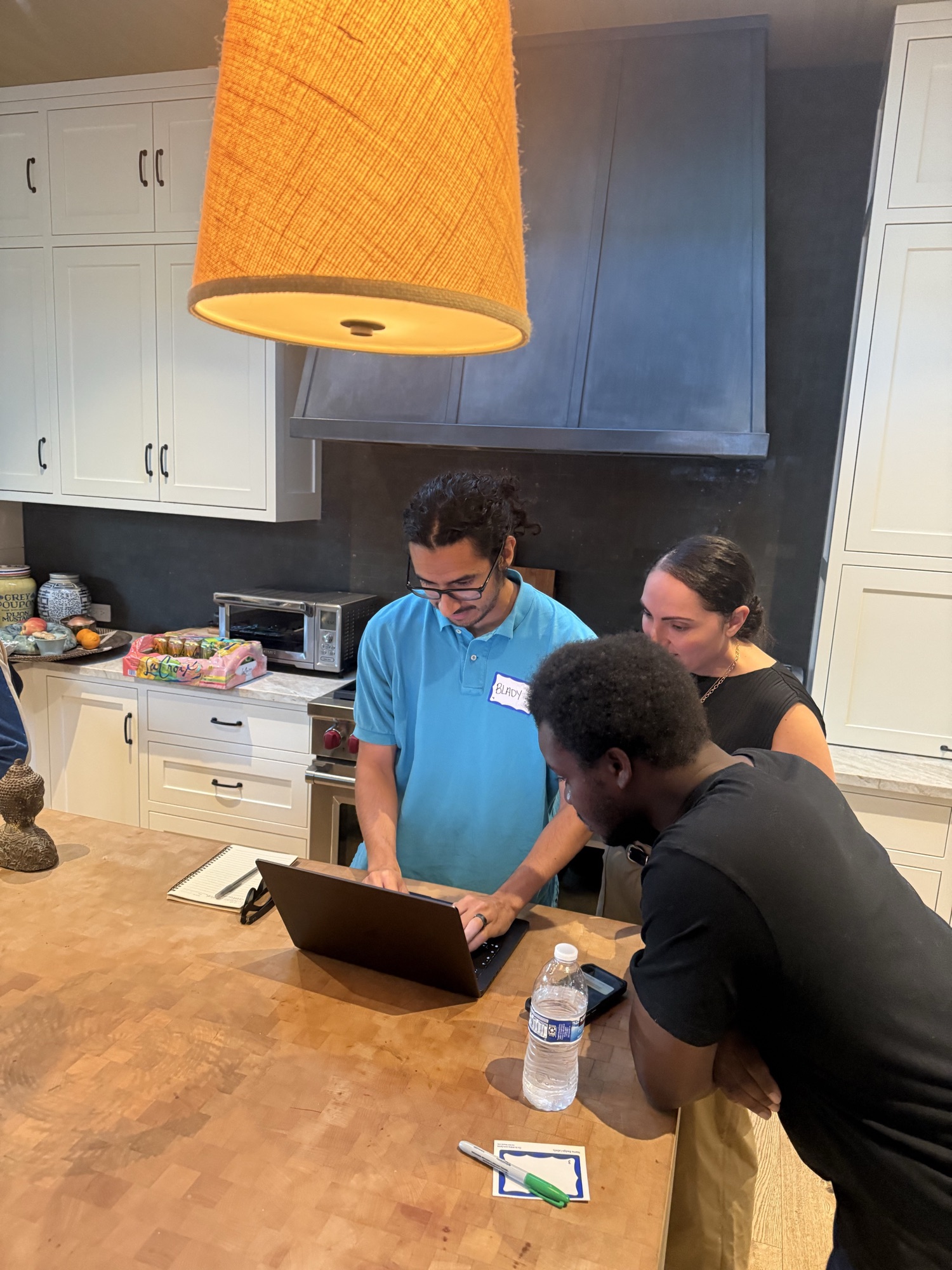 Eastside alumni collaborating around a laptop during the workshop